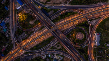 Poster - Road interchange in the city at night with vehicle car light movement, Aerial view.
