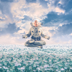 Wall Mural - Dreamer in the field / 3D illustration of surreal science fiction scene with meditating astronaut levitating over a field of flowers under a glorious sky
