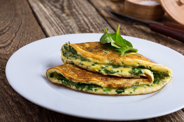 Wall Mural - Baby spinach and parmesan cheese omelette, healthy vegetarian breakfast