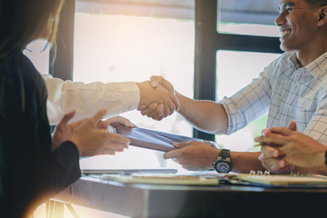 Businessman handshake and sending contract at business meeting after negotiations with business partners