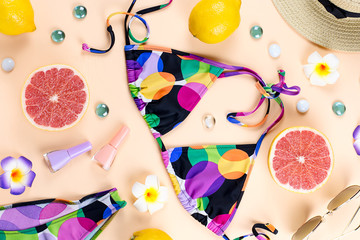 Bikini swimsuit with straw hat, flowers and fruits, flat design, summer concept. Beach destination, summer fashion