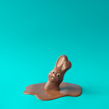 Easter Chocolate Bunny Rabbit Melting. Creative Easter Holiday Concept Background. Minimal Style.