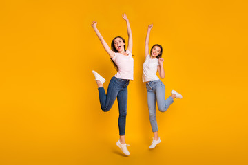 Wall Mural - Full length body size view portrait of nice charming attractive cheerful overjoyed slim fit thin straight-haired girls having fun rejoice isolated on bright vivid shine yellow background