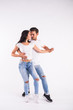 © satura_ - Young couple dancing social latin dance bachata, merengue, salsa. Two elegance pose on white background