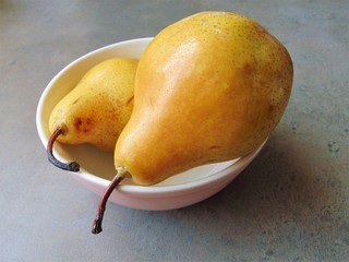 Two pears in the bowl. Healthy fruits.