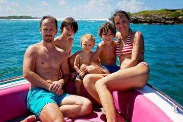 Sticker - Happy beautiful family, children and parents, dressed in beach wear, enjoying day trip with speed boat