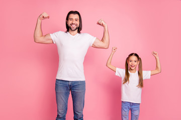 Sticker - Close up photo beautiful she her little small lady he him his daddy showing muscular hands arms fists one team teamwork winners wear casual white t-shirts denim jeans isolated pink bright background