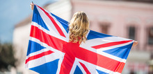 Attractive Happy Young Girl With The Flag Of The Great Britain