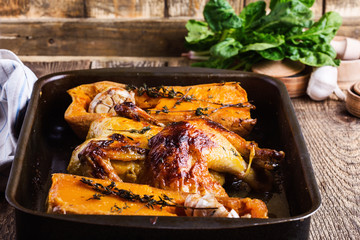 Wall Mural - Roasted chicken with seasonal autumn butternut squash, garlic and herbs