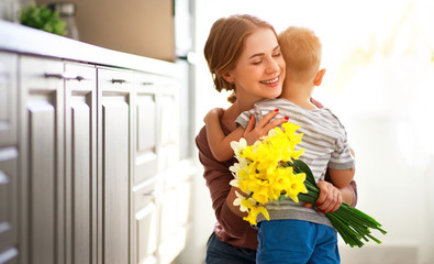 happy mother's day! child son gives flowersfor  mother on holiday .