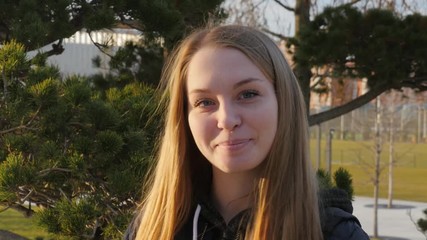 a young girl smiles at the camera.