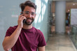 © Deboraht - young man talking mobile phone in the airport