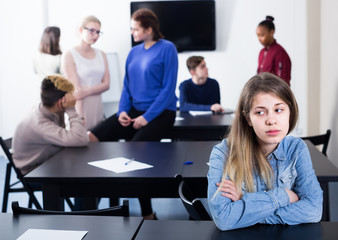 Wall Mural - sad female student feeling uncomfortable at break between classes