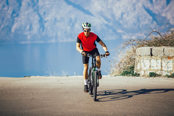 Man ride mountain bike on the road. Sport and active life concept.