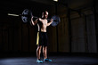 © baranq - Athletic man exercising with barbell at gym