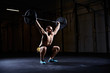 © baranq - Athletic man training squats with barbells over head
