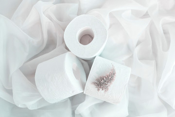 Slightly hazed White toilet paper rolls on drapery cloth. Top view, Closeup. Copy space.