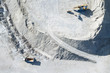 Rocks and machines in a gravel pit seen from above