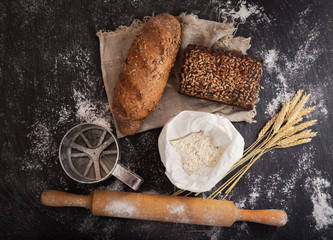 Sticker - fresh bread with wheat ears, flour and kitchen utensils on dark board