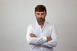 © Sergio Barceló - Fashion portrait of handsome young man with brown hair and a serious expression, looking at the camera. Isolated on white background.