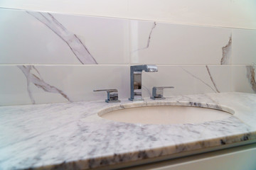 Light bathroom with marble counter top