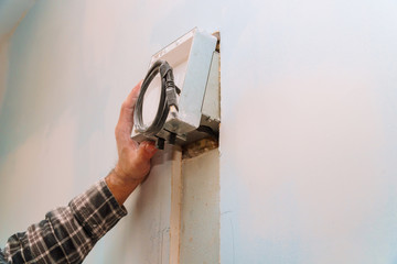 Wall Mural - builder at work. cutting wall of electrical work including exposed wires