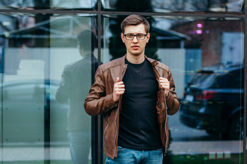 Wall Mural - A stylish man in a black T-shirt. Street photo