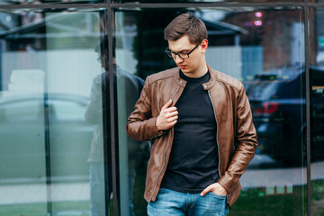 Wall Mural - A stylish man in a black T-shirt. Street photo