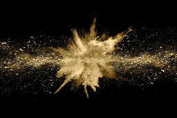 Wall Mural - golden powder explosion on black background. freeze motion.