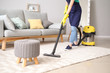 canvas print picture - Female janitor with vacuum cleaner in room