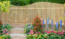 Entrance And Wooden Fence Of Backyard Flower Garden