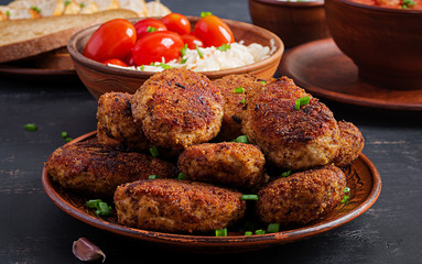 Juicy delicious meat cutlets on a dark table. Russian cuisine.