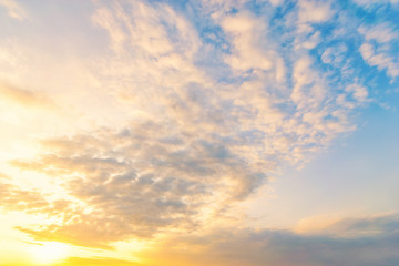 Wall Mural - Sky blue and orange light of the sun through the clouds in the sky