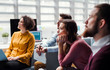 © Halfpoint - Group of young businesspeople in office, listening to a presentation.
