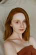 © Lyuba Burakova/Stocksy - Portrait of young ginger  woman with freckles