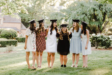 Female Graduates In Dresses And Caps, No Gowns