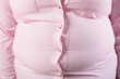 © New Africa - Overweight woman in tight shirt, closeup. Obesity and weight loss