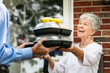© Sean Locke Photography/Stocksy - Meal: Senior Woman Happy To Get Meals And Visit