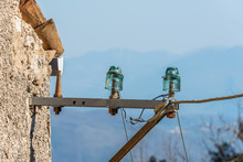 Antique Green Glass Electric Insulators In An Abandoned Village In Italy