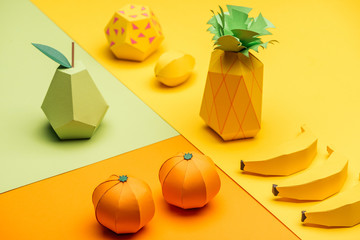 Sticker - various handmade colorful origami fruits on green, yellow and orange paper