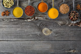 Fototapeta Nowy Jork - Wooden table of colorful spices.