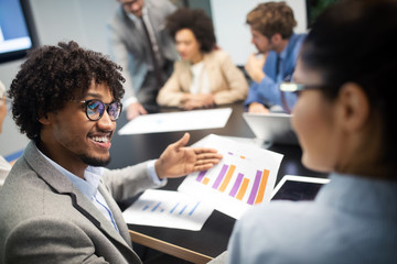 Image of business partners discussing documents and ideas