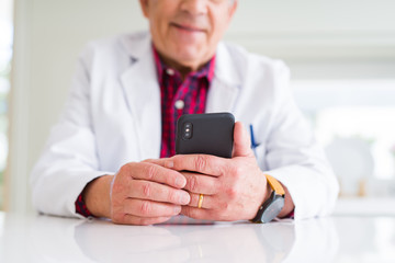 Sticker - Close up of doctor hands using smartphone at the clinic and smiling