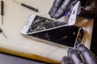 © yaroslav1986 - Technician or engineer opening broken smartphone for repair or replace new part on desk