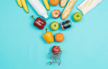 Grocery Shopping Products Falling Into A Trolley