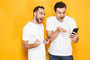 Canvas Print - Two cheerful excited men friends wearing blank t-shirts