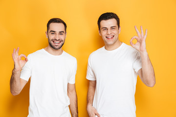 Canvas Print - Two cheerful excited men friends wearing blank t-shirts