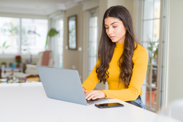 Wall Mural - Beauitul young woman working using computer laptop concentrated