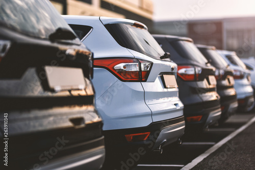 Leinwand Poster  cars parked in row on outdoor parking