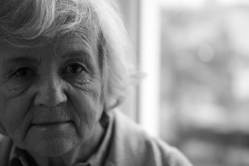 Wall Mural - Portrait of elderly woman indoors, space for text. Black and white effect